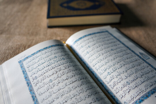 Indonesia - July, 2022 : The Quran, also romanized Qur'an or Koran, is central religious text of Islam, believed by Muslims to revelation from God (Allah). Classical Arabic. Sack, Blue.  white. Open.
