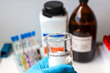 sodium bisulfite powder in glass, chemical in the laboratory