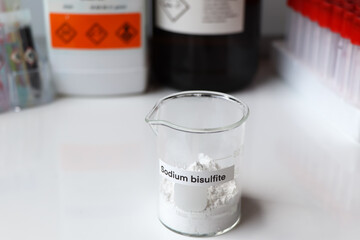 sodium bisulfite powder in glass, chemical in the laboratory