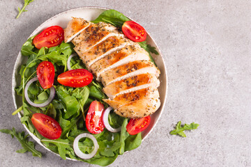 Salad with grilled chicken fillet meat, fresh vegetables, spinach, ruccola, red onion and tomato. Healthy menu. Diet food. Top view. Banner 