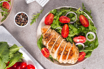 Salad with grilled chicken fillet meat, fresh vegetables, spinach, ruccola, red onion and tomato. Healthy menu. Diet food. Top view. Banner 