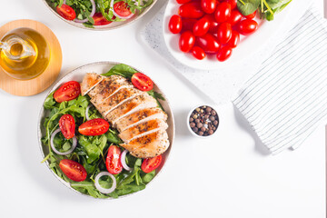 Salad with grilled chicken fillet meat, fresh vegetables, spinach, ruccola, red onion and tomato. Healthy menu. Diet food. Top view. Banner 
