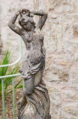 Fototapeta na wymiar Ancient stone sculpture of a naked woman