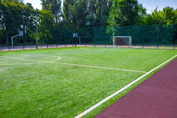 Obraz na płótnie Canvas Sports ground, field with artificial turf for playing soccer and other ball sport games.