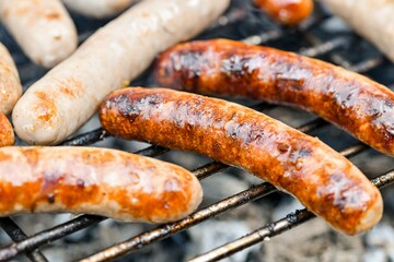 Marinated grilled sausages are fried on a fire.