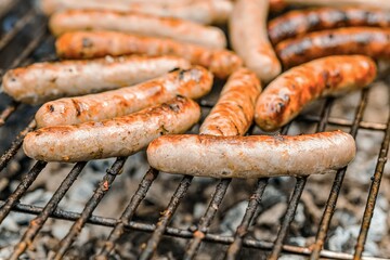 Grilled sausages on the fire are on the grill and are ready to eat.