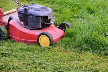 Lawn mower on mowed lawn grass.