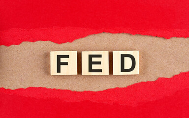 FED word on wooden cubes on red torn paper , financial concept background