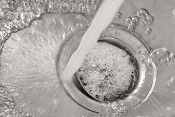Detail of water jet falling down a drain