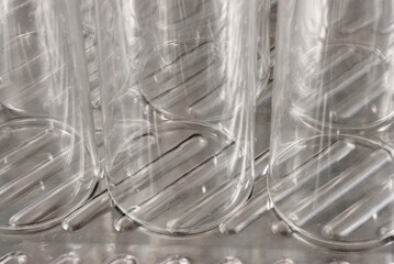 Several soap covered glasses in a sink