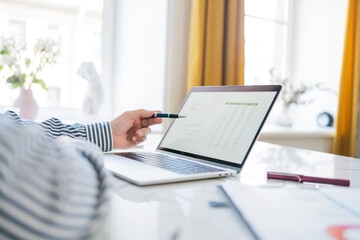 Workplace in the office the manager makes an online report in a financial company, uses graphs