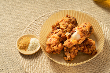 Fresh fried chicken legs on a simple background