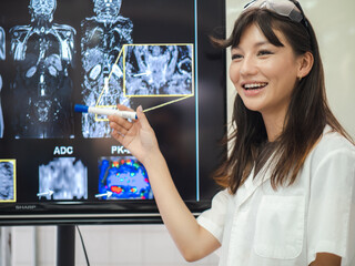 Female doctor check film x-ray image for patient medical care. Surgeon woman examining x-ray film...