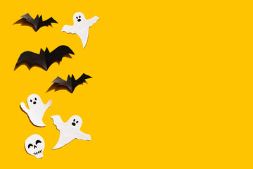 Halloween set decorations with ghost, bat and skeleton on yellow background. Holiday party, minimal card, spooky concept. flat lay, copy space, top view, place for text