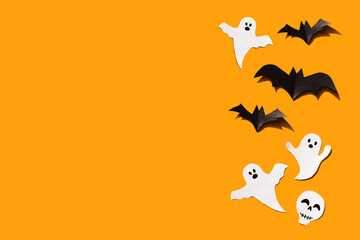 Halloween set decorations with ghost, bat and skeleton on orange background. Holiday party, minimal card, spooky concept. flat lay, copy space, top view, place for text