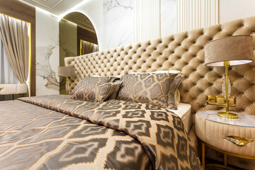 luxury hotel bedroom. Bed with carriage coupler headboard