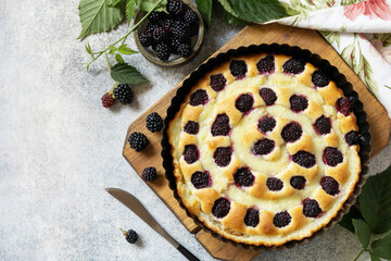 Vegan gluten-free pastry. Homemade blackberry pie. Sweet pie with blackberry and custard on stone...