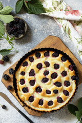 Vegan gluten-free pastry. Homemade blackberry pie. Sweet pie with blackberry and custard on stone tabletop.