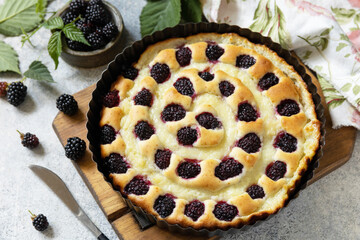Vegan gluten-free pastry. Homemade blackberry pie. Sweet pie with blackberry and custard on stone tabletop.