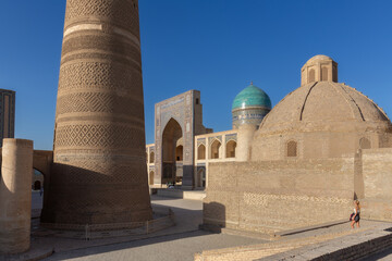 Poi-Kalyan square with Kalyan minaret and ancient madrasah with blue dome, Bukhara, Uzbekistan