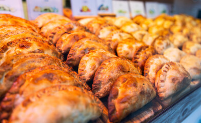 freshly baked empanadas with different fillings for sale