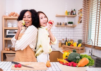 African American woman in white shirt by the window holds a mug in her hands.holding a cup of coffee or tea.Freedom life enjoy with hot drink beverage in a morning breakfast.Interior window curtain.