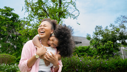 Obraz premium Happy African mother having fun with her daughter park outdoor.Family and love concept. Mother day celebration concept.Happy young mother having fun with her child in summer day .