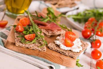 Crispy rye bread with sesame seeds, ham and cottage cheese.