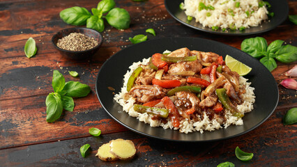 Stir fry pepper chicken with sweet peppers, onion, garlic and ginger