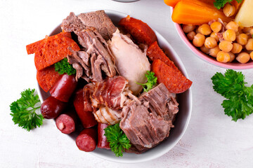 Assorted stewed meat: beef, pork, chicken, bacon, smoked and chorizo sausages. Cocido madrileno, traditional hot Spanish meal ingredients 