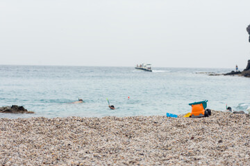Fototapeta na wymiar Playa de Los Muertos in Spain, children toys on the sand