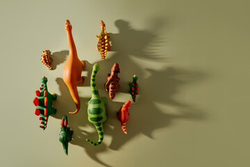 Toy dinosaurs with shadows on green background. Toys for Kids.  Games for learning and development...