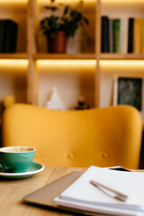 modern living room with table, laptop and cup of coffee