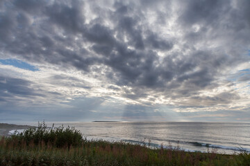 Sunbeams passing through the clouds over the sea