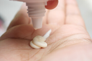 Close up of sunscreen cream on hand 