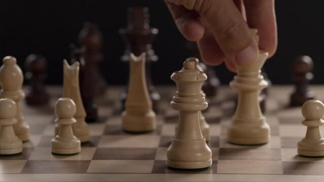 A hand moving a chess piece