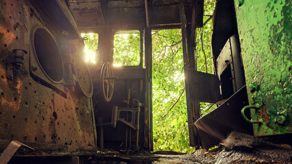 interior of an old abandoned train in a forest or jungle with rusty steampunk decoration - damaged dark and creepy wagon in the nature