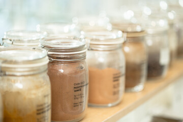 Eco-friendly zero waste shop interior. Dispensers for cereals, nuts and grains in sustainable plastic free grocery store. Shopping at small local businesses