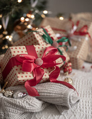 Fototapeta na wymiar Festive gift boxes under the Christmas tree, close-up.