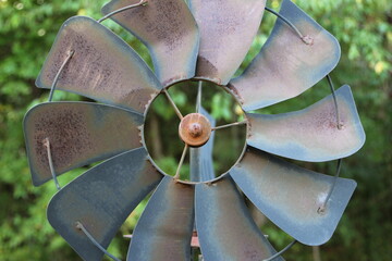 Old rusty windmill, landscaping close up, farmhouse decorations. 