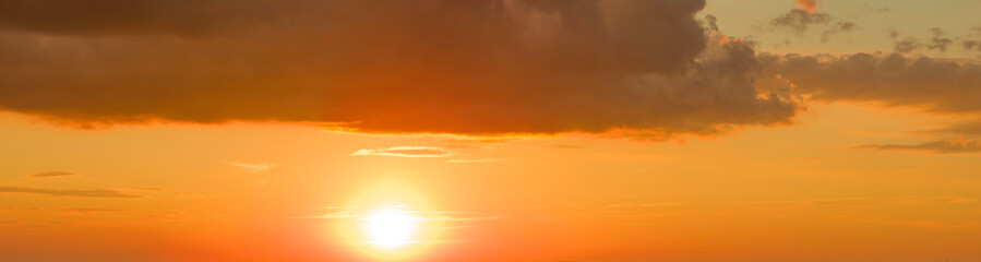 Naklejka na ściany i meble Colorful orange sky at sunset with clouds