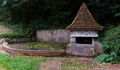 Fototapeta na wymiar Old fountain along the Chemin du Puy, French route of the way of St James