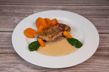 Recipe for baked lamb shoulder with watercress mashed, sweet potato and carrot, pepper sauce, cognac and fresh cream. High quality photo