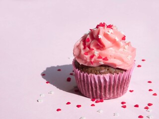 Cupcake on a purple background with side lighting and a place for text