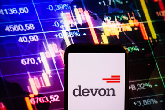 KONSKIE, POLAND - August 30, 2022: Smartphone displaying logo of Devon Energy company on stock exchange chart background
