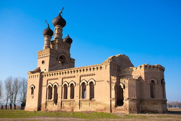 Obraz premium Old ruined church. Bent crosses and broken walls of the temple, ancient forged frames on the windows. Christian monastery.