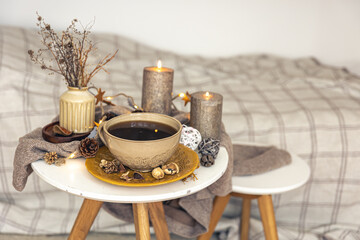 Cozy autumn composition with a cup of tea and decorative details.