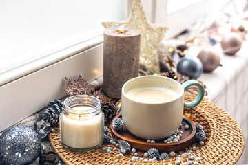 Cozy home composition with a cup of coffee and decor, close-up.