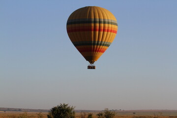Hot air baloon flying above savannah planes in Maasai Mara Kenya