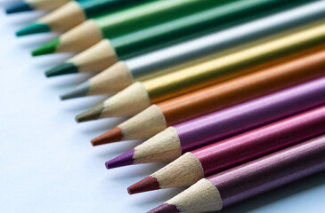 Colored pencils with a metallic sheen close-up. Background with place for text. High quality photo